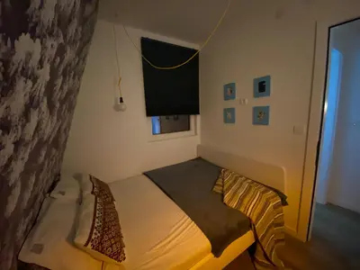 a small bedroom with a bed in a room at Apartman L8 Kopaonik in Kopaonik