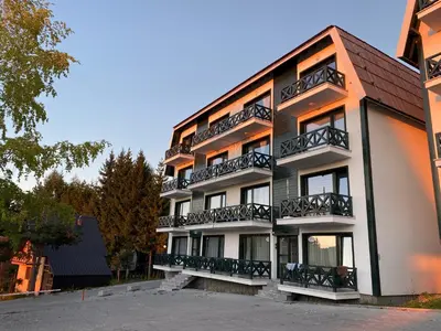 a building with balconies on the side of it at Apartman L8 Kopaonik in Kopaonik