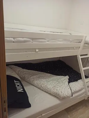 a white bunk bed with two pillows on the bottom shelf at Kopaonik Jaram ski lift slope Karaman in Kopaonik