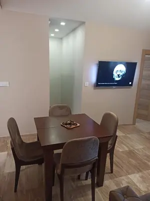 a dining room with a table and chairs and a tv at Kopaonik Jaram ski lift slope Karaman in Kopaonik