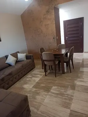 a living room with a couch and a table and chairs at Kopaonik Jaram ski lift slope Karaman in Kopaonik