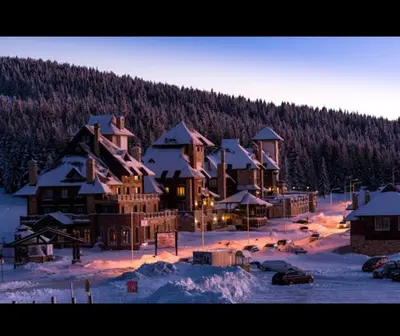 a large lodge in the snow with snow covered trees at Kopaonik Jaram ski lift slope Karaman in Kopaonik
