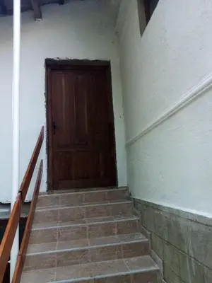 a staircase with a wooden door in a room at Apartmani Lina in Ribarska Banja