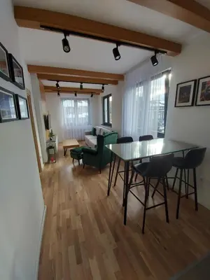 a living room with a table and chairs and a couch at Apartman Djordje-vila Montana in Kopaonik