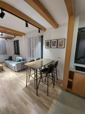 a dining table and chairs in a living room at Apartman Djordje-vila Montana in Kopaonik