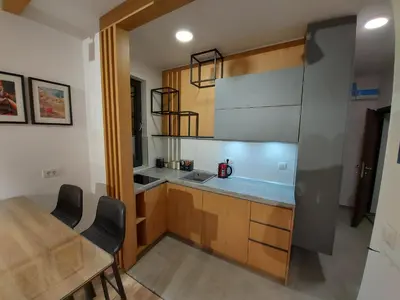a kitchen with a dining room table and a counter top at Apartman Djordje-vila Montana in Kopaonik