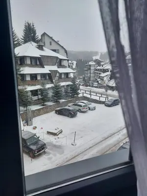 a view from a window of a parking lot with cars at Apartman Djordje-vila Montana in Kopaonik