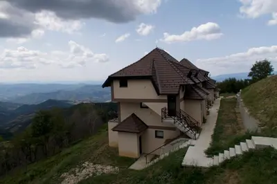 a building on the side of a hill at Dvori Sky View E13 Kopaonik - free private parking in Kopaonik