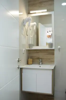 a bathroom with a sink and a mirror at Dvori Sky View E13 Kopaonik - free private parking in Kopaonik