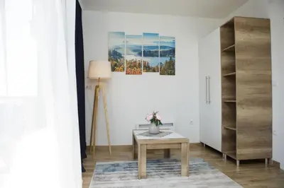 a living room with a table and a lamp at Dvori Sky View E13 Kopaonik - free private parking in Kopaonik