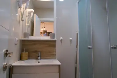 a bathroom with a sink and a mirror at Dvori Sky View E13 Kopaonik - free private parking in Kopaonik