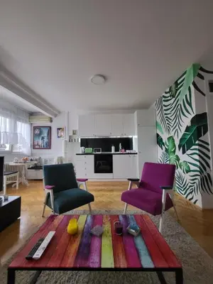 a living room with a table and two chairs at Happy Place in Niš