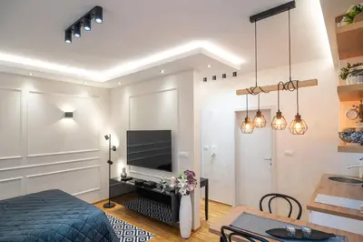 a bedroom with a bed and a tv on a wall at Zvezda Lux in Vrnjačka Banja