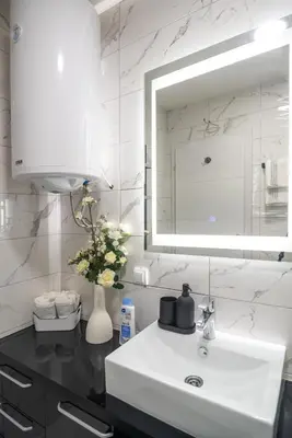 a bathroom with a white sink and a mirror at Zvezda Lux in Vrnjačka Banja
