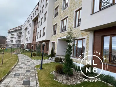 a row of apartment buildings with a sign that reads m no reborn at Milmari Lux N8 in Kopaonik