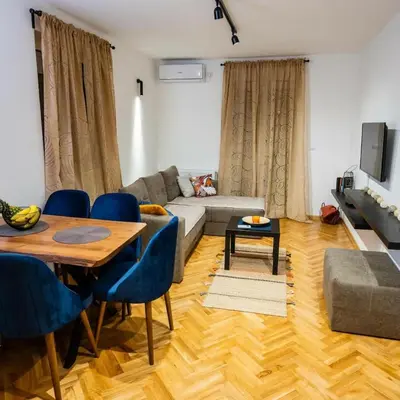 a living room with a couch and a table at Godimento Vrnjačka Banja in Vrnjačka Banja