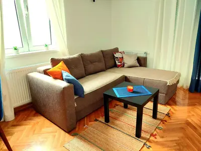 a living room with a couch and a table at Godimento Vrnjačka Banja in Vrnjačka Banja