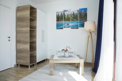 a living room with a table and a painting at Dvori Sky View E14 Kopaonik - free private parking in Kopaonik