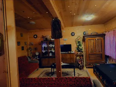 a living room with a couch and a tv at Radetov konak in Ðunis