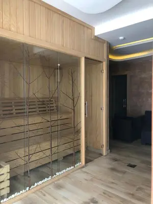 a room with wooden walls and glass doors at Vila Planinsko Blago Luxury Apartmans in Kopaonik