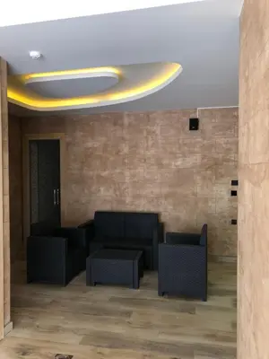 a lobby with couches and chairs in a building at Vila Planinsko Blago Luxury Apartmans in Kopaonik