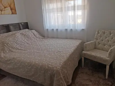a bedroom with a bed and a chair at Bellavista in Vrnjačka Banja