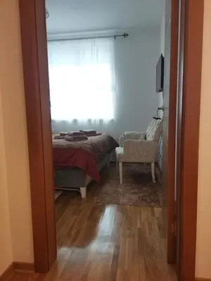 a bedroom with a bed and a window and a chair at Bellavista in Vrnjačka Banja