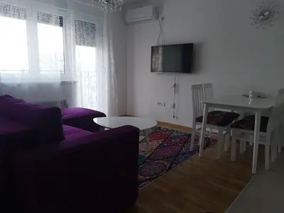 a living room with a purple couch and a table at Bellavista in Vrnjačka Banja