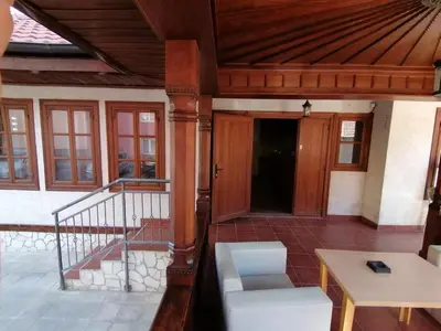 a porch of a house with a wooden ceiling at MON Accommodation free parking in Niš