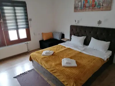 a bedroom with a large bed with two towels on it at MON Accommodation free parking in Niš