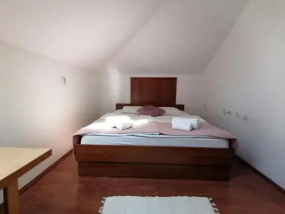 a bedroom with a bed with two towels on it at MON Accommodation free parking in Niš