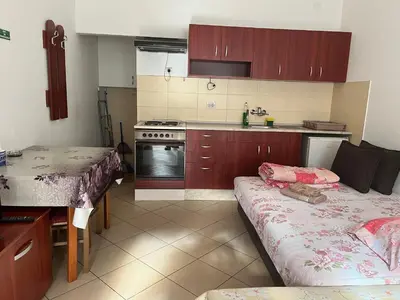 a kitchen with a table and a couch in it at Mladenović smeštaj in Soko Banja