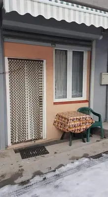 a bench sitting in front of a building at Mladenović smeštaj in Soko Banja