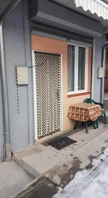 a bench sitting in front of a building at Mladenović smeštaj in Soko Banja