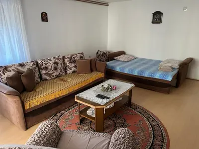 a living room with a couch and a bed at Smestaj Miki in Soko Banja