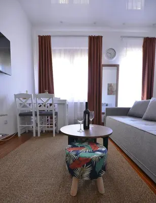 a living room with a table and a couch at Lux Pegaz 008 in Vrnjačka Banja