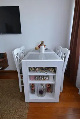 a small white table with a shelf and a tv at Lux Pegaz 008 in Vrnjačka Banja