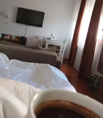 a room with a bed with a cup of coffee at Lux Pegaz 008 in Vrnjačka Banja