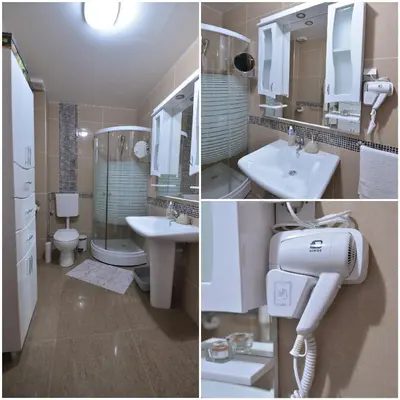 a bathroom with two sinks a toilet and a shower at Lux Pegaz 008 in Vrnjačka Banja
