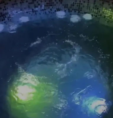 a bath tub filled with blue and green water at Lux Pegaz 008 in Vrnjačka Banja
