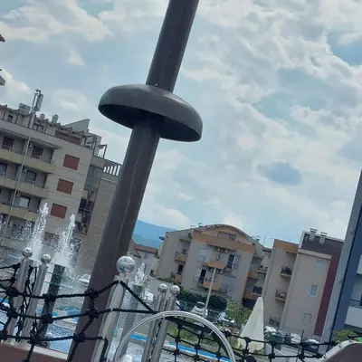 a fountain in the middle of a city with buildings at Lux Pegaz 008 in Vrnjačka Banja