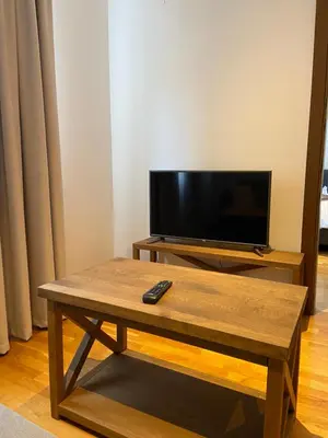 a living room with a tv and a coffee table at BRZECE SKI GONDOLA & FREE PARKING apartment in Kopaonik
