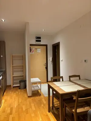 a room with a table and chairs and a kitchen at BRZECE SKI GONDOLA & FREE PARKING apartment in Kopaonik