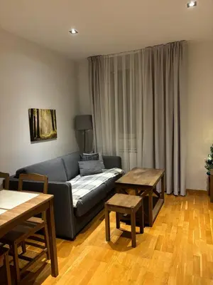 a living room with a couch and two tables at BRZECE SKI GONDOLA & FREE PARKING apartment in Kopaonik