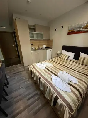 a bedroom with a large bed with towels on it at Apartman Pahuljica in Kopaonik