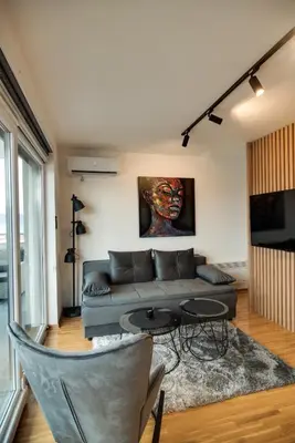 a living room with a couch and a table at IN LUX SPA APARTMAN in Vrnjačka Banja