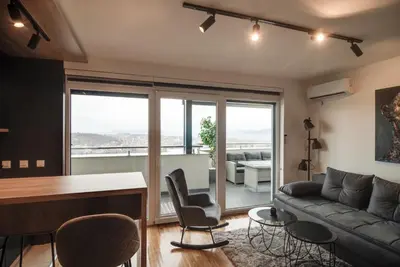 a living room with a couch and a table at IN LUX SPA APARTMAN in Vrnjačka Banja