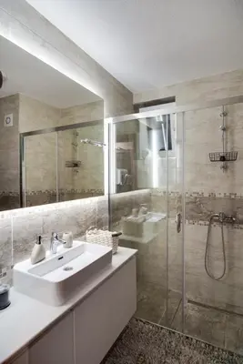 a bathroom with a sink and a glass shower at IN LUX SPA APARTMAN in Vrnjačka Banja