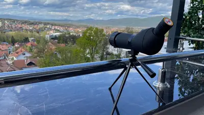 a camera on a tripod with a view of a city at IN LUX SPA APARTMAN in Vrnjačka Banja