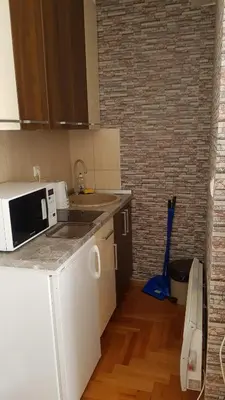 a kitchen with a sink and a microwave on a counter at Čar30 Kraljevi čardaci in Kopaonik